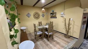 a dining room with a table and chairs at Hospedaje in Salento +20 photos