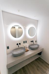 two sinks in a bathroom with two mirrors at atsumaro in Minamiboso