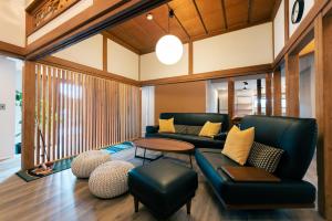 a living room with a couch and a table at atsumaro in Minamiboso
