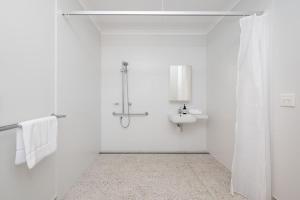 a white bathroom with a sink and a shower at Greenview Place - Officer in Officer +26 photos