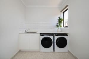 a kitchen with two washing machines and a sink at Greenview Place - Officer in Officer