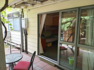 a sliding glass door on the side of a house at Eco Lodge Pakowhai in Hastings +13 photos