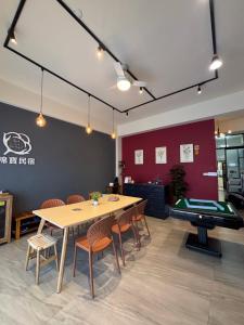 a dining room with a table and a pool table at Mian Bao Homestay in Magong