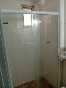 a shower with a glass door in a bathroom at Studio Premium Trianon Centro in Campos dos Goytacazes +17 photos