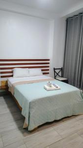 a bedroom with a large bed with a cake on it at HOUSSE 69 Café Bar in Satipo
