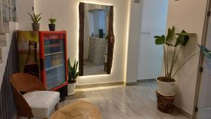 a room with a mirror and a chair and plants at HOUSSE 69 Café Bar in Satipo