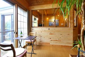 a dining room with a table and a window at 民宿なずな in Tosa