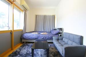 a living room with a couch and a bed at 民宿なずな in Tosa +59 photos