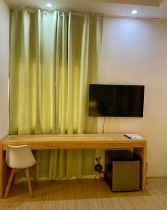a flat screen tv sitting on top of a wooden table at Bakoko Garden in El Nido