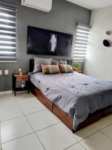 a bedroom with a bed with a horse head on the wall at Depa Colón in Mazatlán