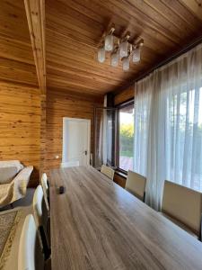 a dining room with a large wooden table and chairs at Семейный коттедж in Bulan Sogottuu