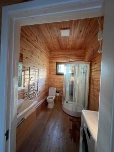 a wooden bathroom with a toilet and a sink at Семейный коттедж in Bulan Sogottuu +21 photos