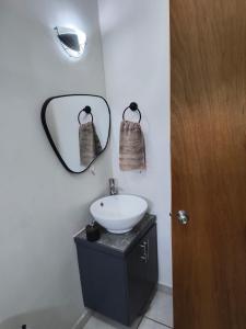 a bathroom with a sink and a mirror at Depa Colón in Mazatlán