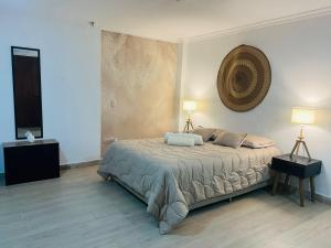 a bedroom with a bed with two lamps on it at Casa Ligia in Medellín