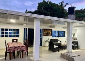 a pergola on a patio with a table and chairs at Hotel Roy in Santa Marta