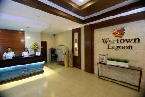 a lobby of a westown london store with two women at a counter at MO2 Westown Lagoon Coron in Coron