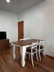 a wooden table and chairs in a room at Villa Dieng Sikapuk Hill Superior Cabin in Kejajar
