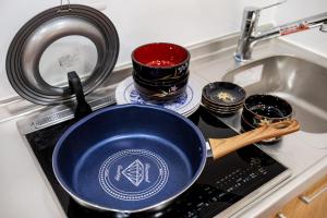 a blue pan sitting on a stove next to a sink at Lucky Today in Osaka +43 photos
