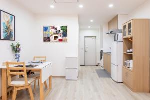 a kitchen with a table and a dining room at Lucky Today in Osaka