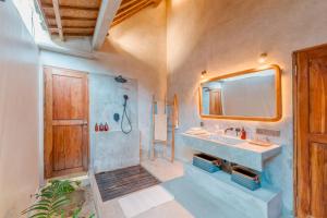 a bathroom with a sink and a mirror at Villa Manouch in Nusa Lembongan +34 photos