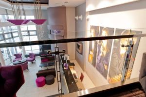 a view of a living room with purple furniture at Hotel 3 Trio in Białystok