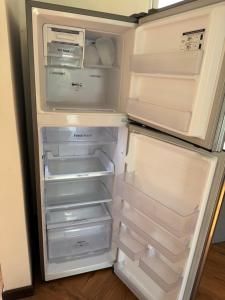 an open refrigerator with its door open and its doorsearchacersacersacersacersngth at Casa Escondida in San Felipe