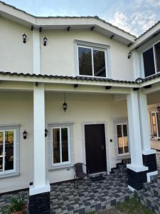a white house with a black door at Casa Escondida in San Felipe