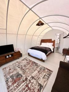 a bedroom with a bed in a tent at Glamping Dieng Sunrise Point Larva Camp in Kejajar