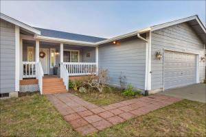 a white house with a porch and a driveway at Ocean Front Clamming Game Room Large Deck in Ocean Shores