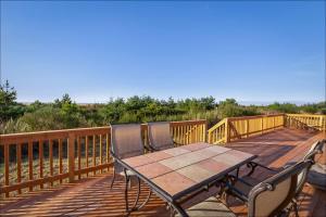 a wooden deck with a picnic table on a boardwalk at Ocean Front Clamming Game Room Large Deck in Ocean Shores
