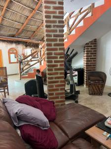 a living room with a couch and a gym at Condominio La Palapa in Bucerías