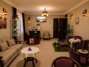 a living room with a couch and tables at Kebena Guest House in Addis Ababa