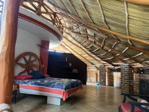 a bedroom with a bed and a wooden ceiling at Condominio La Palapa in Bucerías +47 photos