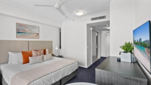 a bedroom with a large bed and a tv at Mantra Hotel Room in Cairns +13 photos