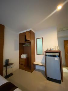 a room with a kitchen with a counter and a mirror at SR Phuket in Patong Beach