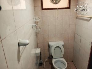 a small bathroom with a toilet and a sink at Casa Scarlet in Bangkok