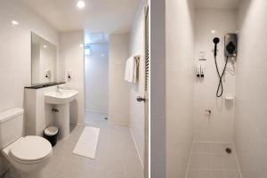 a white bathroom with a toilet and a shower at The Fifth Residence in Bangkok +40 photos
