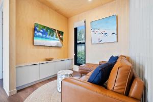 a living room with a couch and a tv at Ingenia Holidays Hervey Bay in Hervey Bay