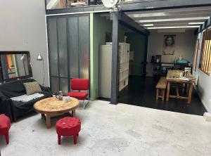 a living room with a couch and a table at Funky artists studio in Paris in Pantin