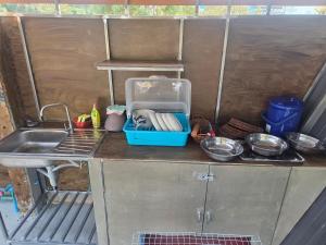 a kitchen with a sink and a counter with utensils at CK Family in Nakhon Nayok