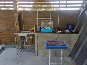 a small kitchen with a sink and a counter at CK Family in Nakhon Nayok