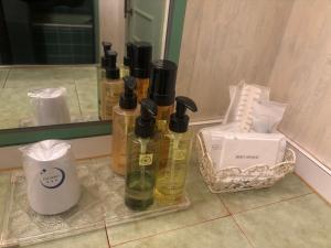 a group of bottles of essential oils sitting on a bathroom counter at Hotel Esta in Miyazaki