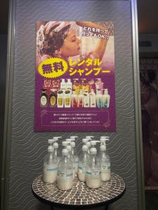 a refrigerator with bottles of milk on a table at Hotel Esta in Miyazaki