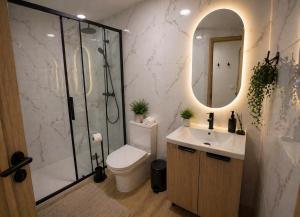 a bathroom with a shower and a toilet and a sink at 77 Lisbon Design Apartment near Airport, Lisbon, Amadora, Odivelas & Sintra in Caneças