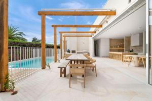 an outdoor patio with a table and chairs and a pool at Lucia Sorrento in Sorrento