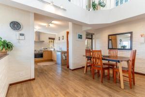 a kitchen and dining room with a table and chairs at 3BR Lakeside Home Mountains Beach Nearby in Cape Town