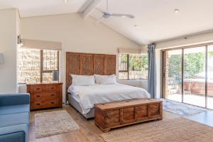 a bedroom with a bed with a wooden headboard at 3BR Lakeside Home Mountains Beach Nearby in Cape Town