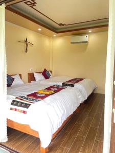 a bedroom with two beds with white sheets at MAI CHAU inn in Mai Châu +16 photos