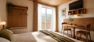 a bedroom with a bed and a table and a window at Pod Zapalenicą w centrum in Szczyrk