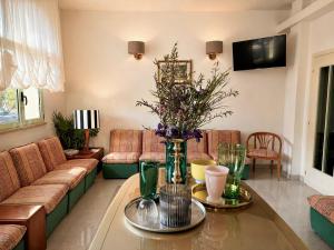 a living room with a couch and a table at Hotel Dover Rooms & Coffee Adults Friendly in Cervia